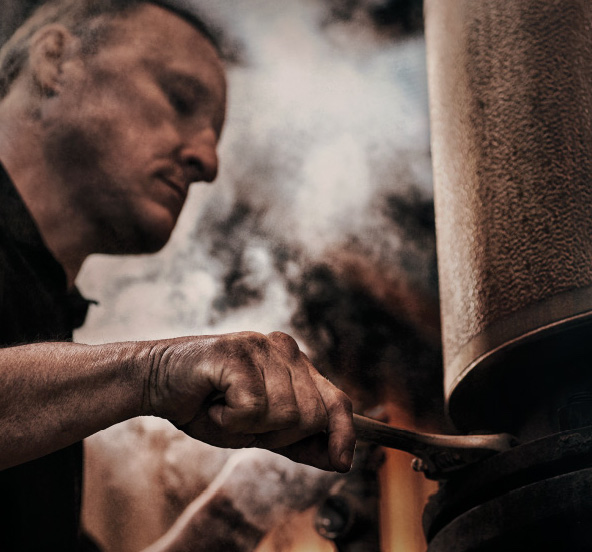 Man with a wrench steam in the background